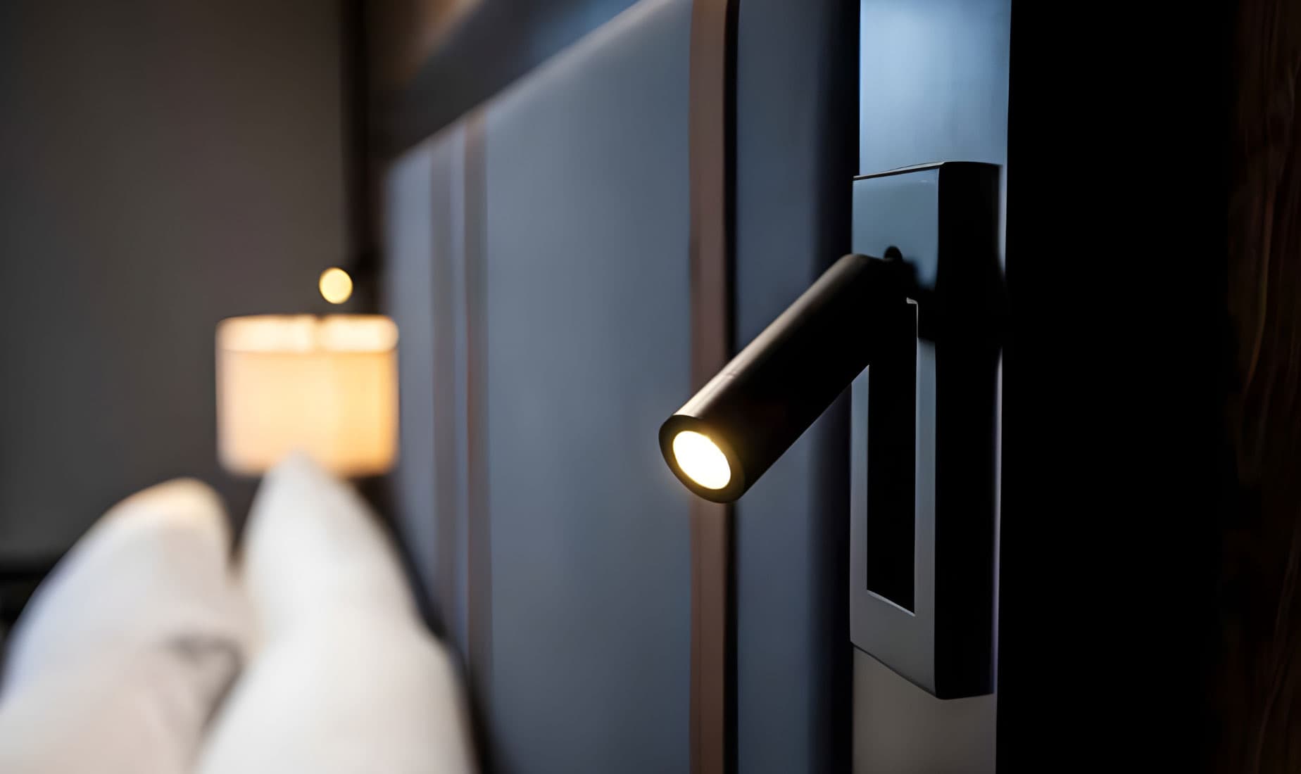 Finished hospitality guest room with integrated bedside lighting
